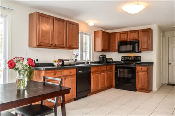 549 Potter Road Framingham, MA 01701 - Photo 2 of 22 a kitchen with granite countertop a sink cabinets and window