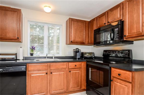 549 Potter Road Framingham, MA 01701 - Photo 3 of 22 a kitchen with granite countertop cabinets stainless steel appliances a sink and a window