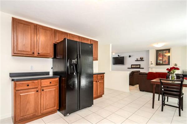 549 Potter Road Framingham, MA 01701 - Photo 5 of 22 a kitchen with stainless steel appliances a refrigerator and wooden cabinets