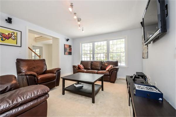 549 Potter Road Framingham, MA 01701 - Photo 8 of 22 a living room with furniture a flat screen tv and a window