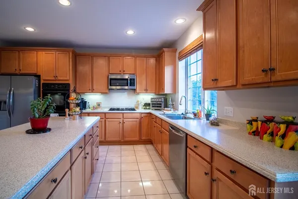 a kitchen with a sink a window and appliances