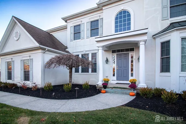 a front view of a house with porch and yard
