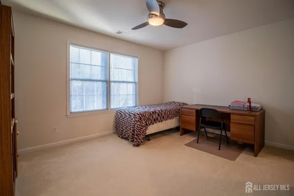 a bedroom with furniture and a window