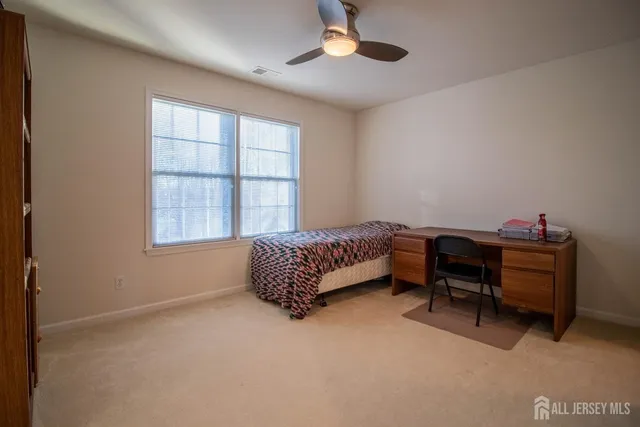 a bedroom with furniture and a window