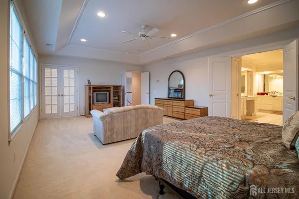 a spacious bedroom with a large bed and a dresser