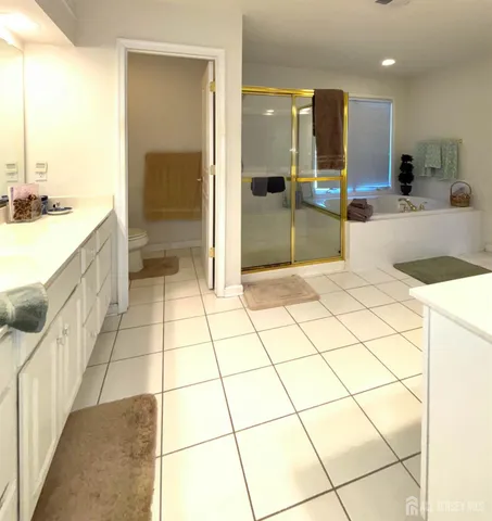 a large bathroom with a glass door shower a sink and a mirror