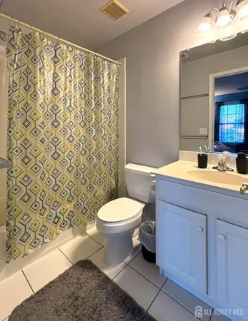 a white toilet sitting next to a bathroom sink
