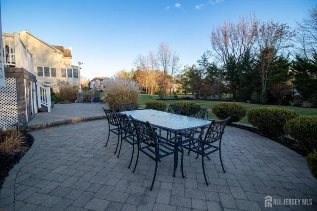 a view of a table and chairs in backyard of the house