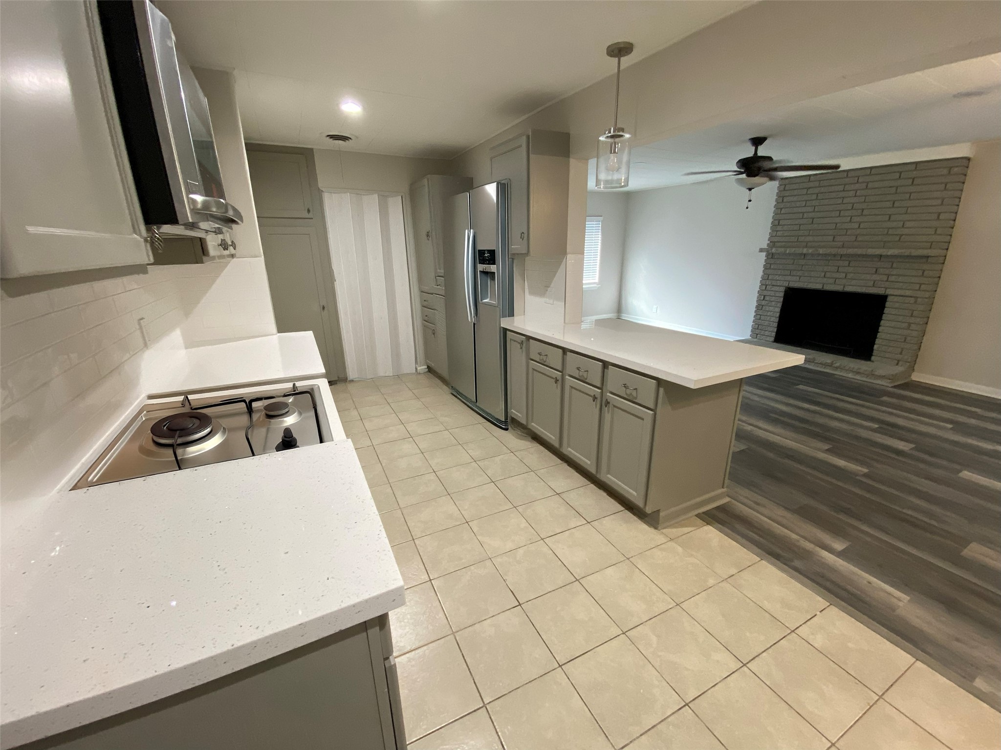 1021 Wimberly Street Angleton, TX 77515 - Photo 2 of 14 a kitchen with a stove and a refrigerator
