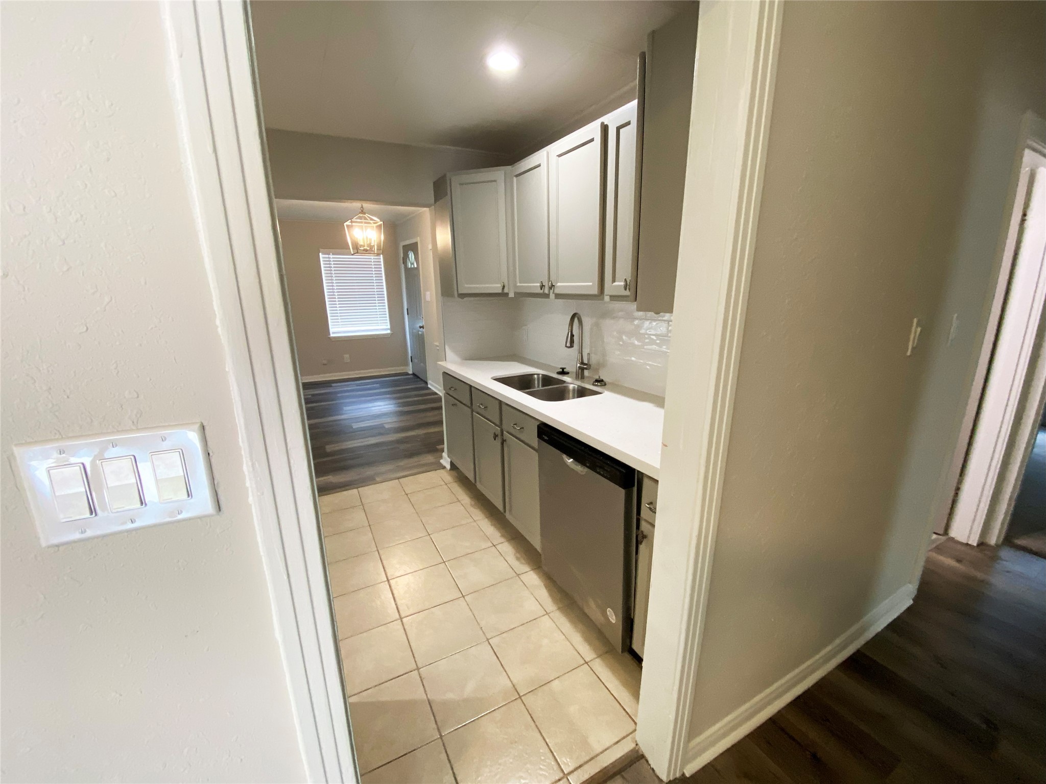 1021 Wimberly Street Angleton, TX 77515 - Photo 6 of 14 a kitchen with kitchen island granite countertop a sink and a refrigerator