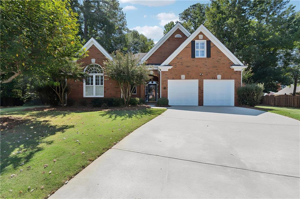 523 Willsford Court Johns Creek, GA 30022 - Photo 1 of 1 a front view of a house with a yard and garage