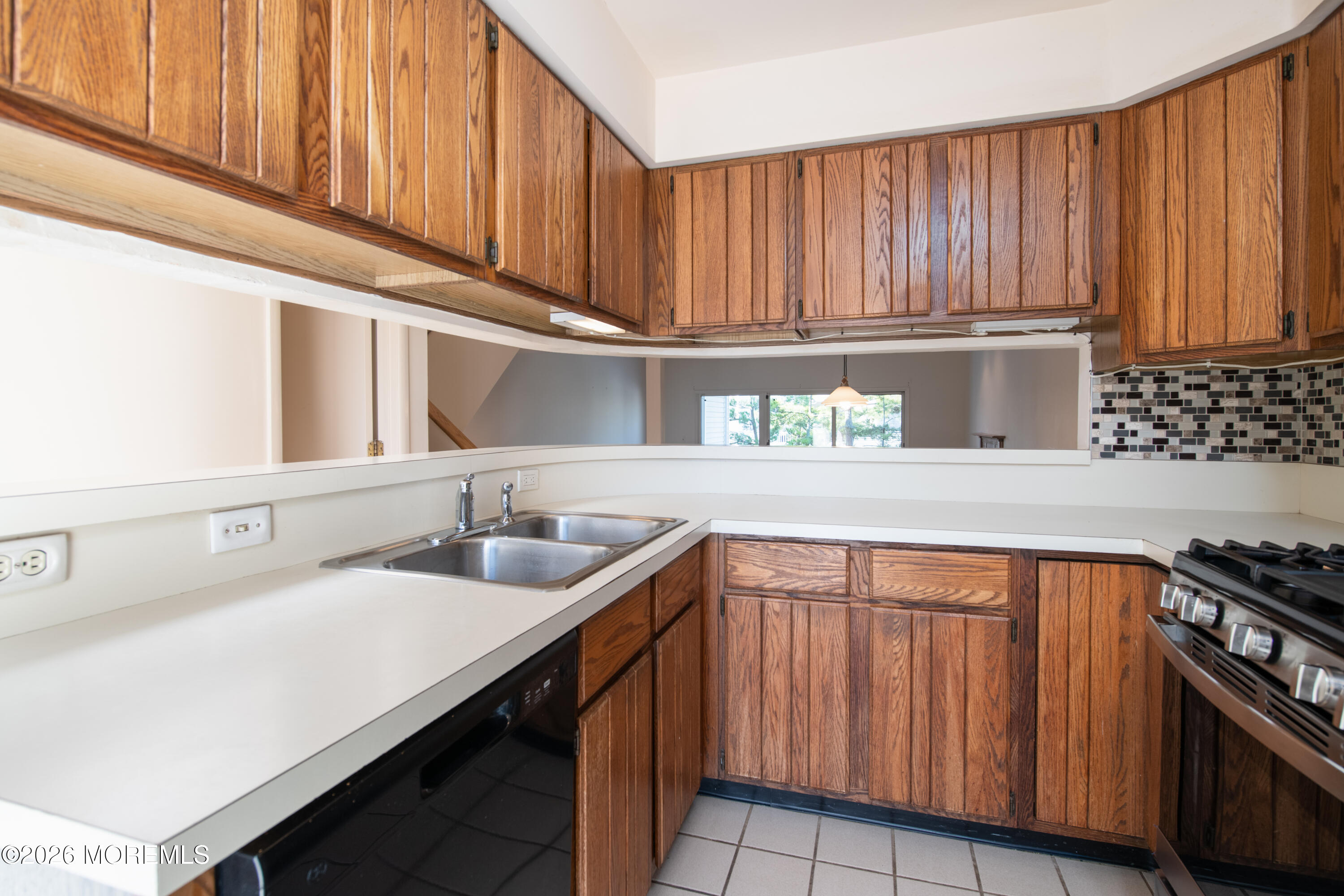 10 Seawinds Way Long Branch, NJ 07740 - Photo 12 of 31 a kitchen with stainless steel appliances a sink dishwasher stove and cabinets