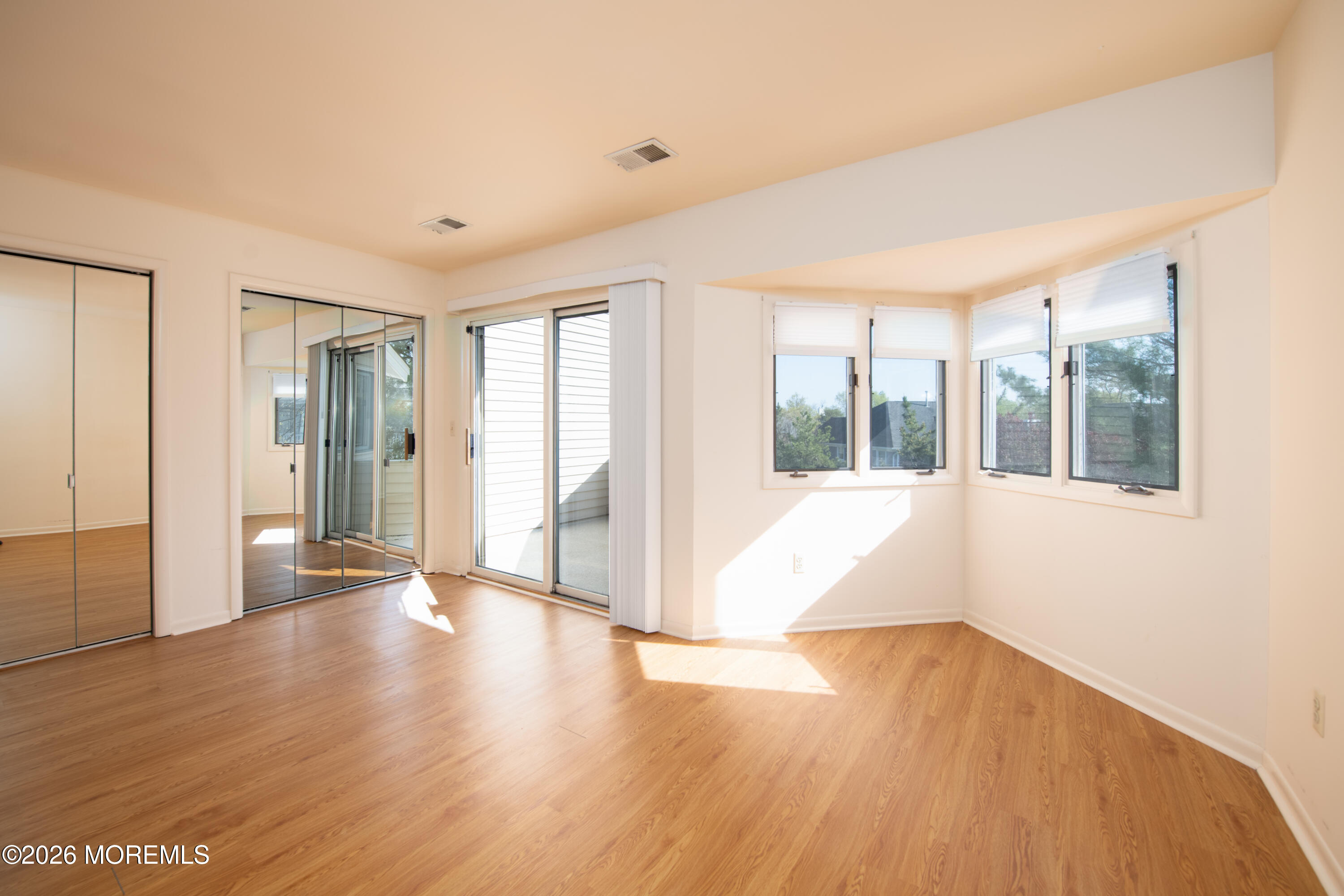 10 Seawinds Way Long Branch, NJ 07740 - Photo 20 of 31 a view of an empty room with wooden floor and a window