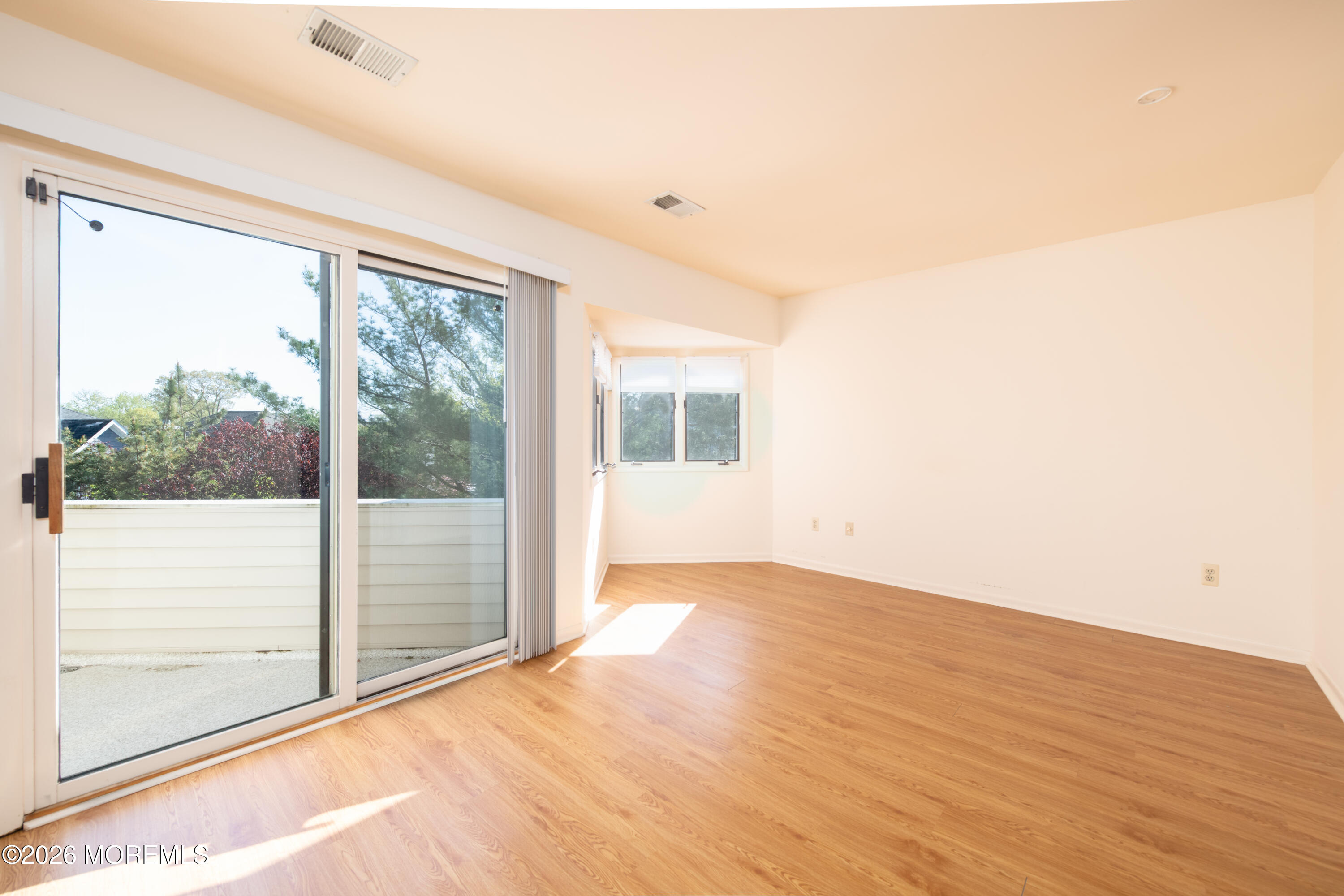 10 Seawinds Way Long Branch, NJ 07740 - Photo 22 of 31 a view of an empty room with wooden floor and a window
