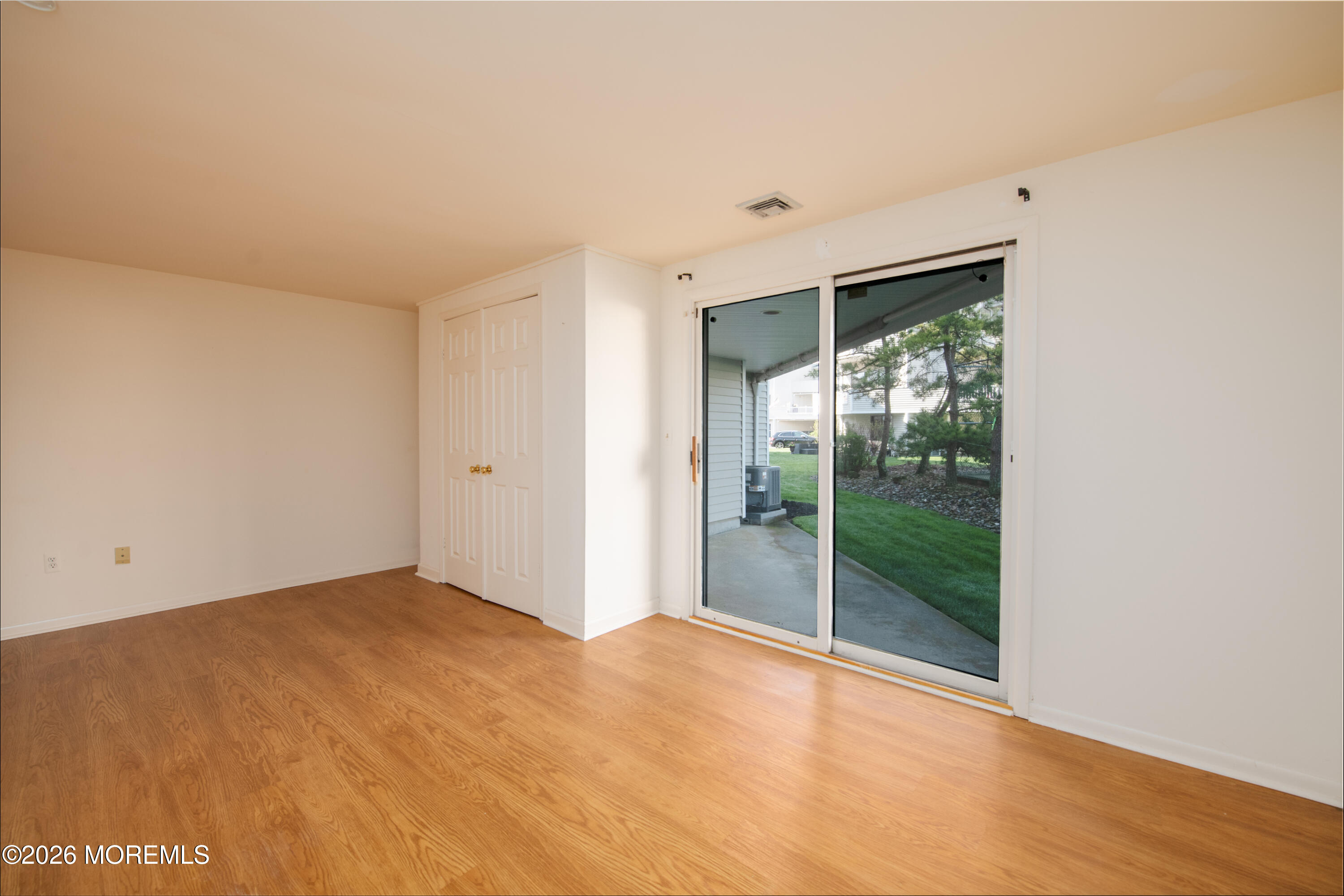 10 Seawinds Way Long Branch, NJ 07740 - Photo 23 of 31 a view of an empty room with wooden floor and a window