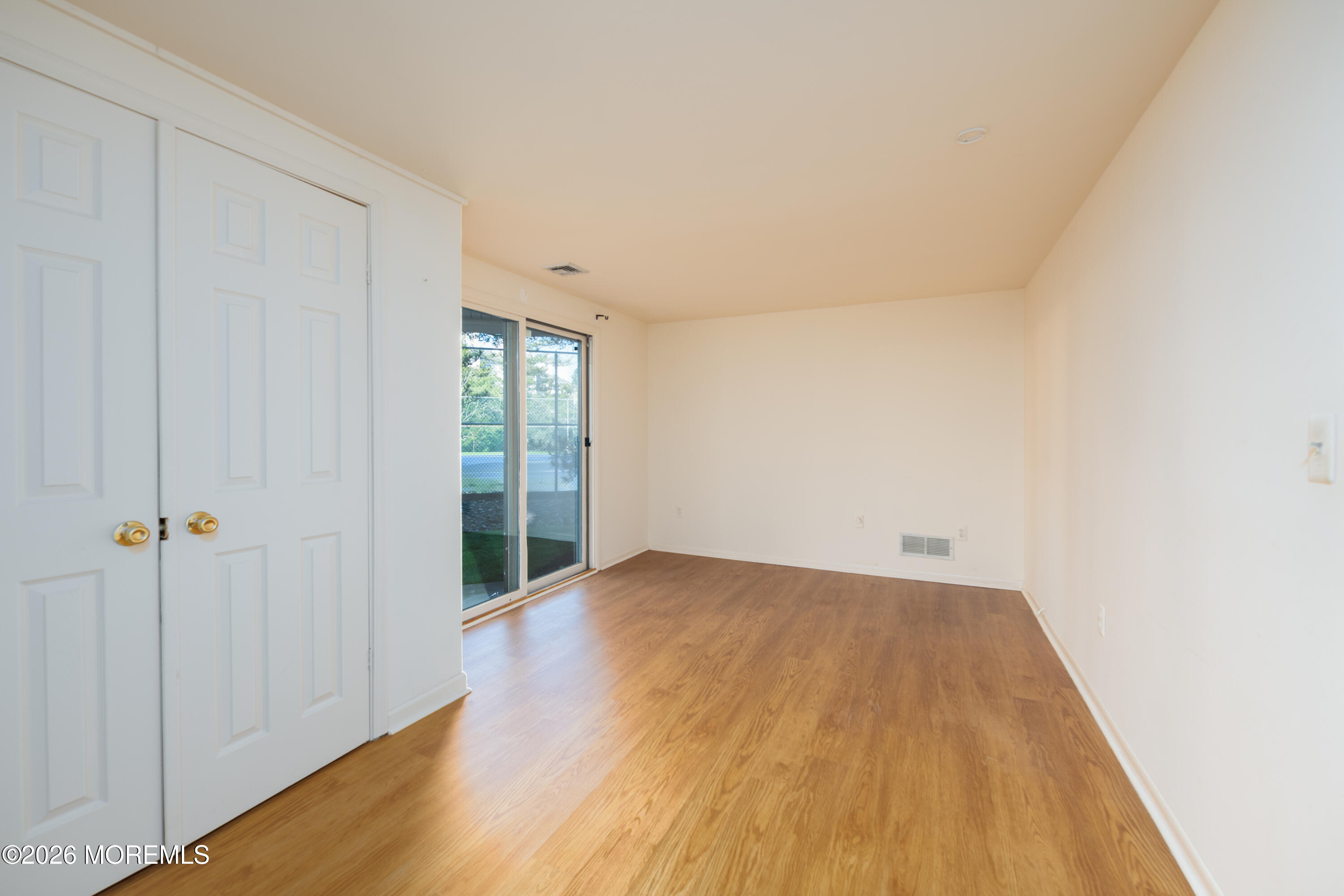10 Seawinds Way Long Branch, NJ 07740 - Photo 25 of 31 a view of an empty room and wooden floor