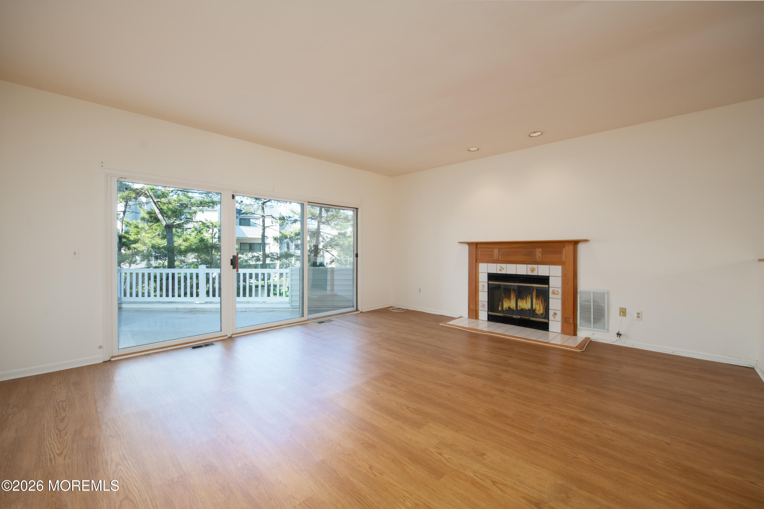 10 Seawinds Way Long Branch, NJ 07740 - Photo 5 of 31 a view of an empty room with wooden floor and a window