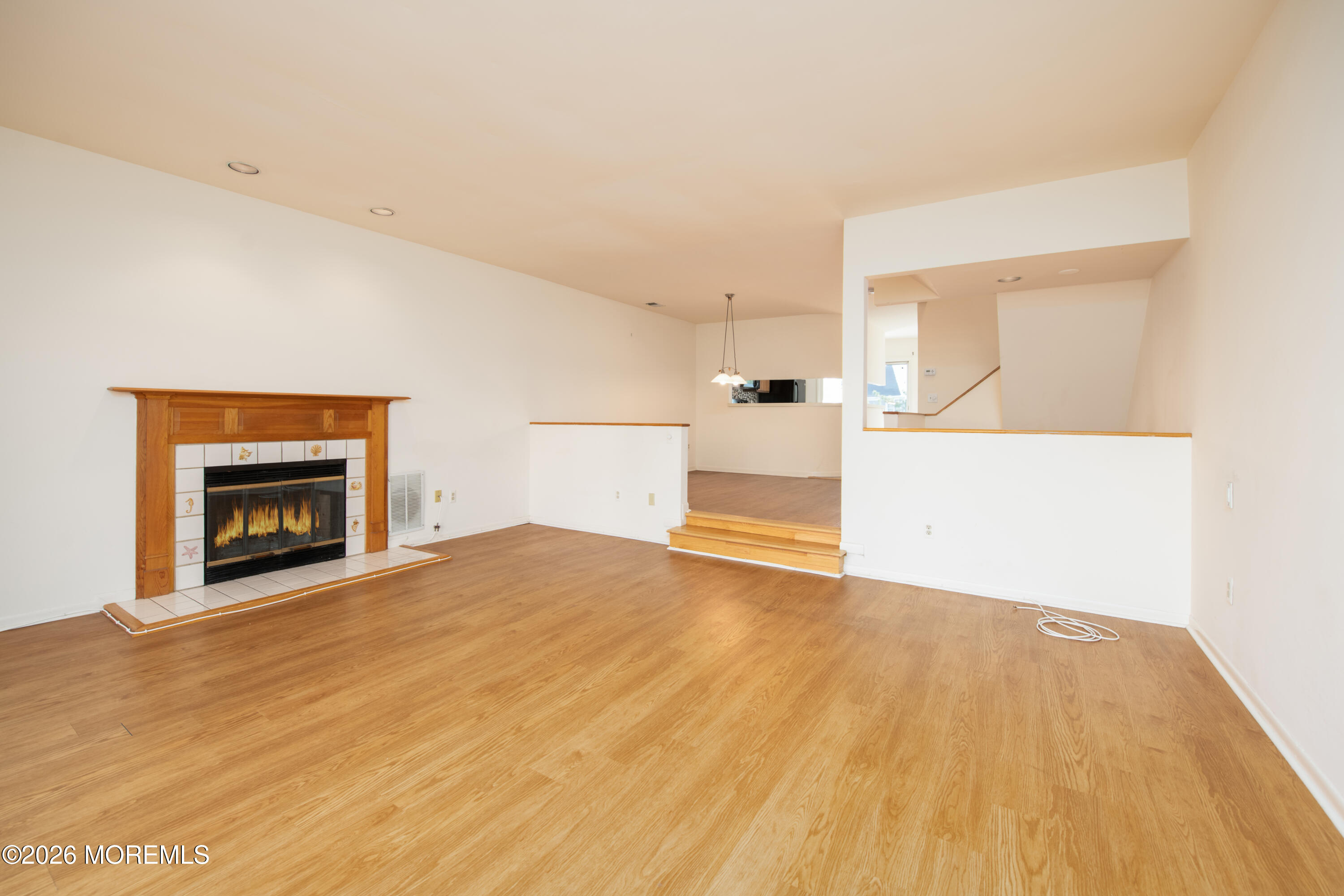10 Seawinds Way Long Branch, NJ 07740 - Photo 6 of 31 a view of empty room with wooden floor and fireplace