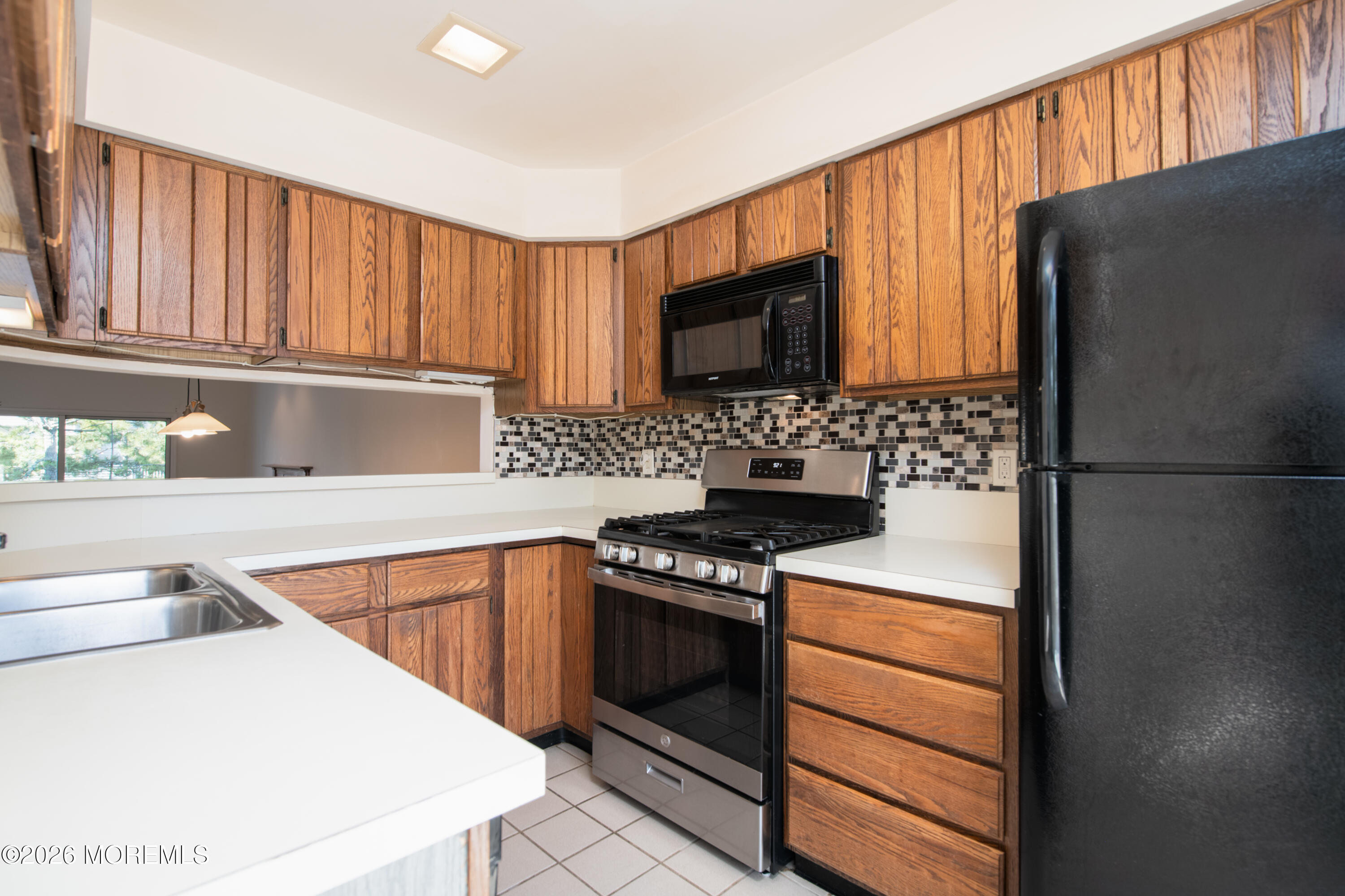 10 Seawinds Way Long Branch, NJ 07740 - Photo 10 of 31 a kitchen with a refrigerator stove and a sink