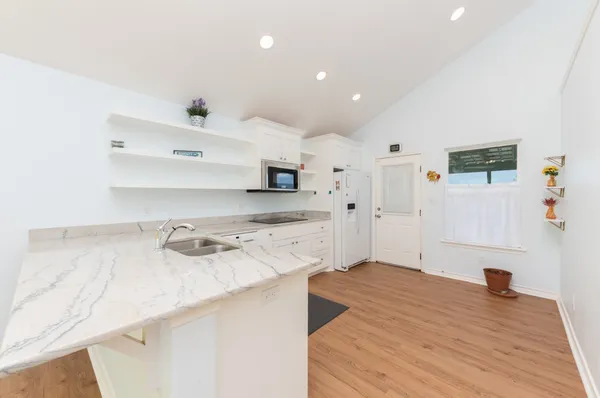 a bedroom with a bed and large window