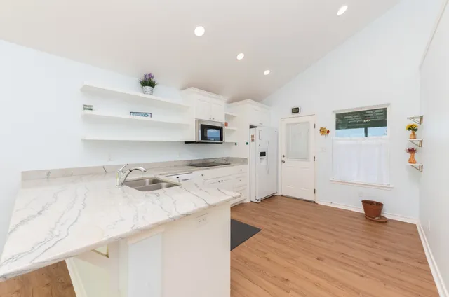 an empty room with a window and wooden floor