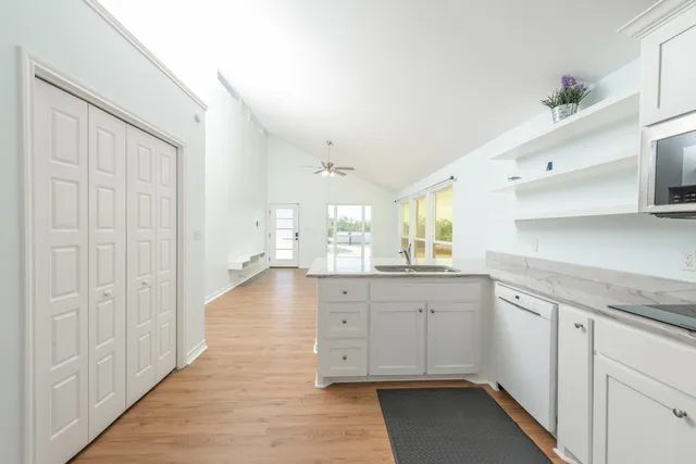 a bathroom with a granite countertop sink toilet and a mirror