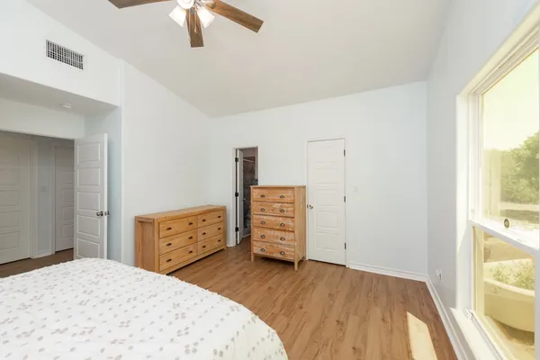 an empty room with a window and wooden floor