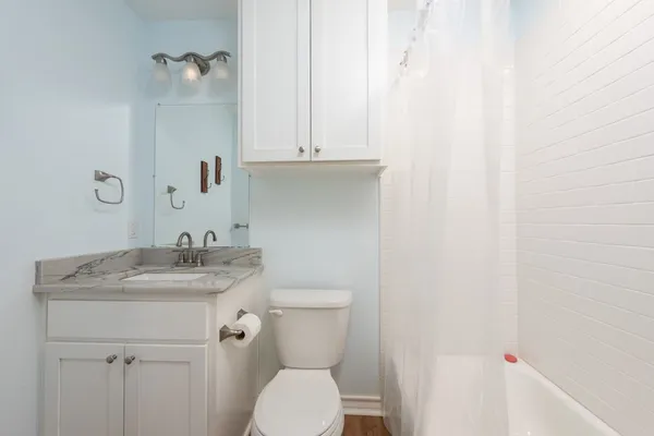 a store room with refrigerator and washer