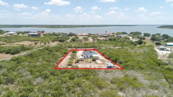 an aerial view of residential houses with outdoor space and river