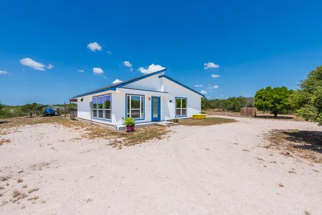 a kitchen with granite countertop white cabinets and stainless steel appliances