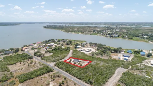 a kitchen with granite countertop white cabinets and stainless steel appliances
