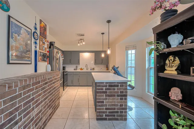 a large kitchen with kitchen island stainless steel appliances stove and cabinets