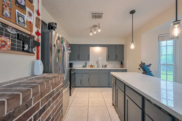 a kitchen with stainless steel appliances a sink stove and refrigerator