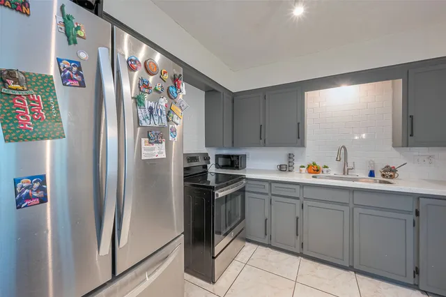 a kitchen with stainless steel appliances and cabinets