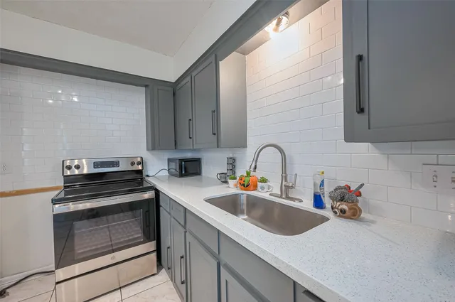 a kitchen with a sink cabinets and stainless steel appliances