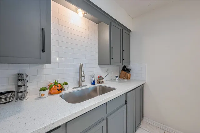 a kitchen with a sink and cabinets