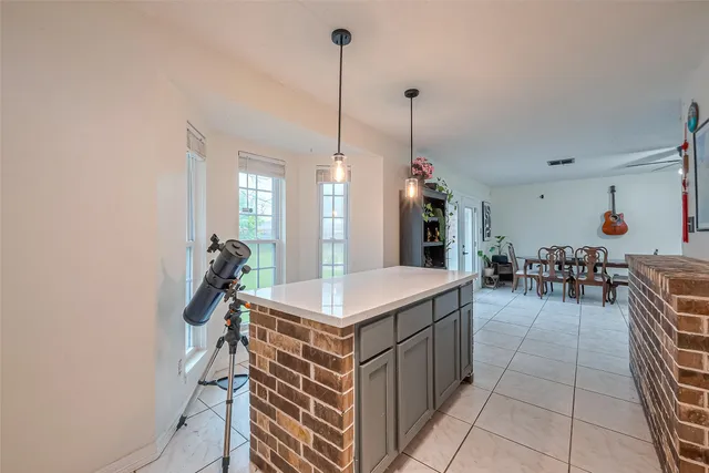 a room with lots of appliances and a view of living room