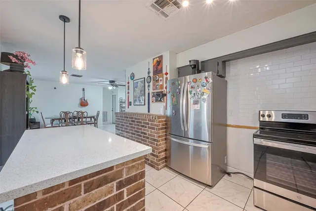 a kitchen with refrigerator and cabinets