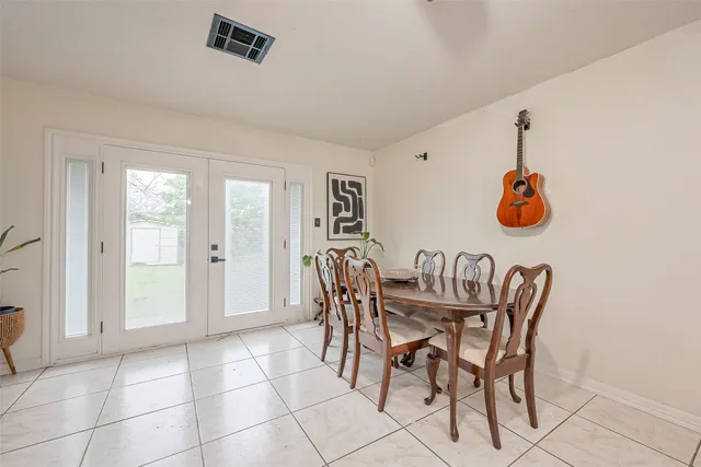 a dining room with furniture and natural light