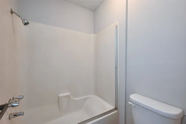 a bathroom with a toilet and a bathtub