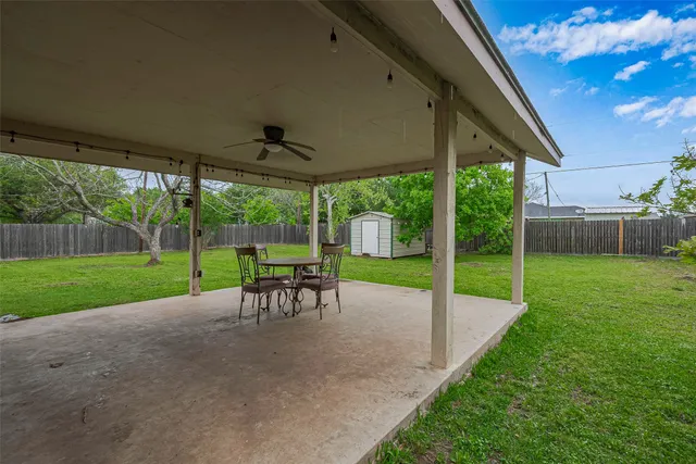 a view of a yard with a table and chairs