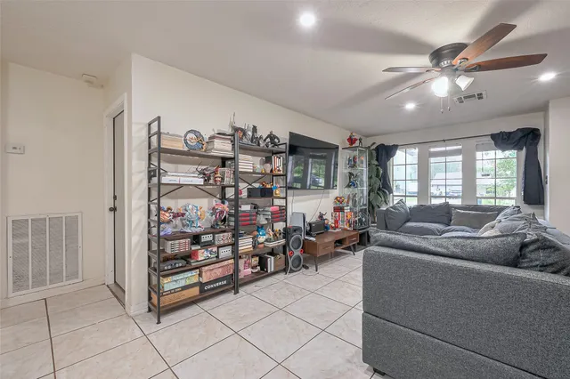 a living room with lots of furniture and white walls