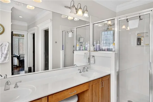a bathroom with a sink double vanity and shower