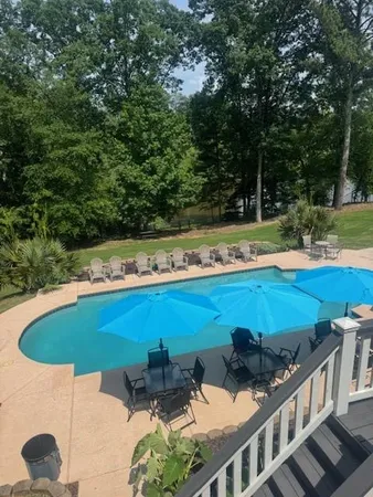 a view of a swimming pool with an outdoor seating