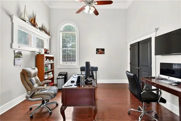 a view of a livingroom with workspace and a window