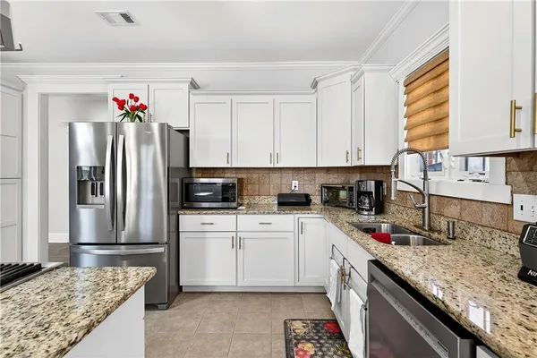 a kitchen with a sink stove and refrigerator