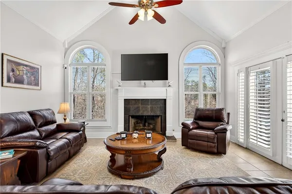a living room with furniture a flat screen tv and a fireplace