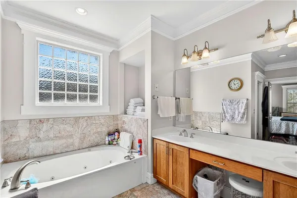 a bathroom with a tub sink and mirror