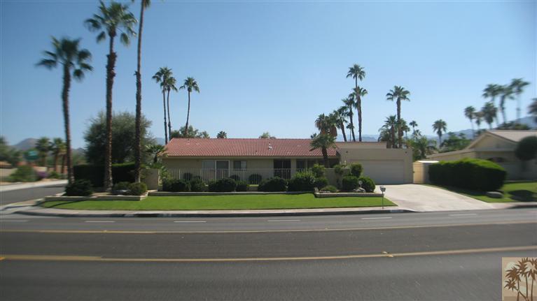 73197 Haystack Road Palm Desert, CA 92260 - Photo 1 of 8 a view of a building with a yard and potted plants