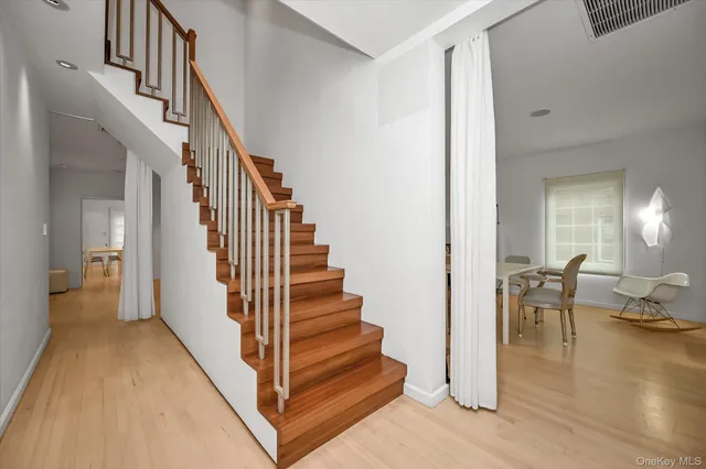 a view of entryway and hall with wooden floor